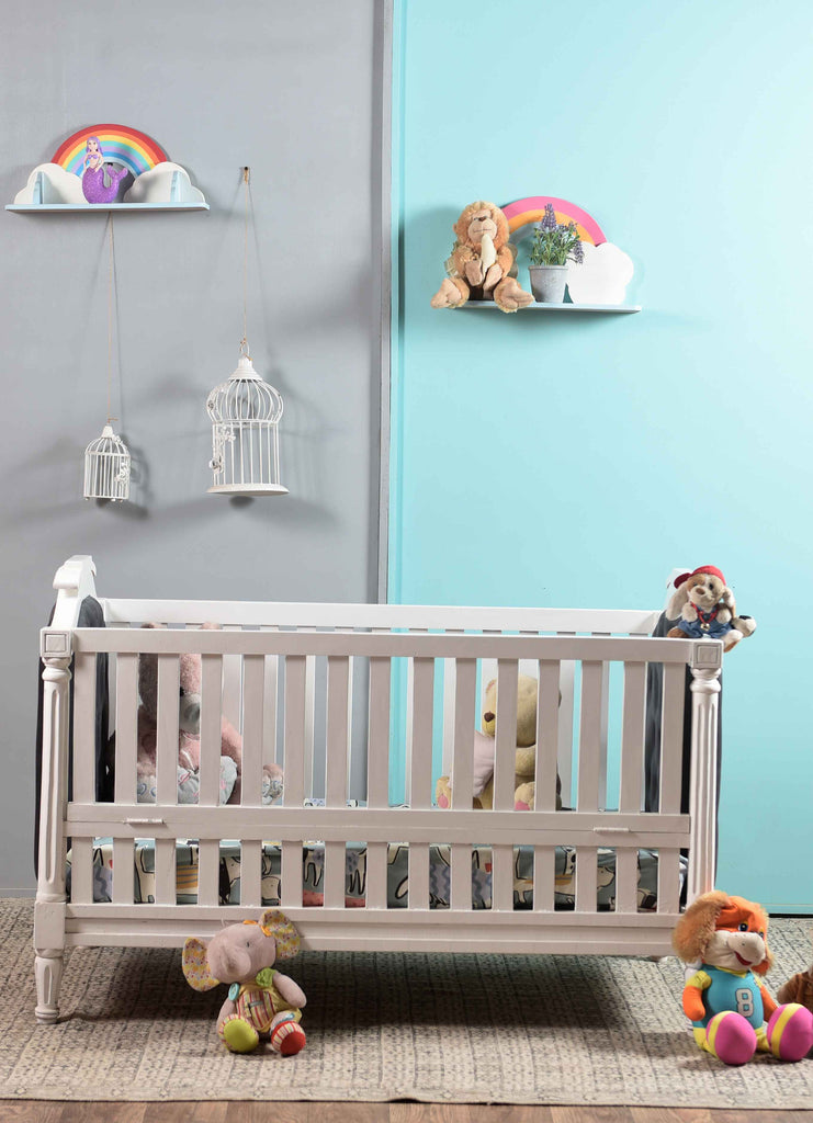 a side angle of Wooden baby crib or cot
