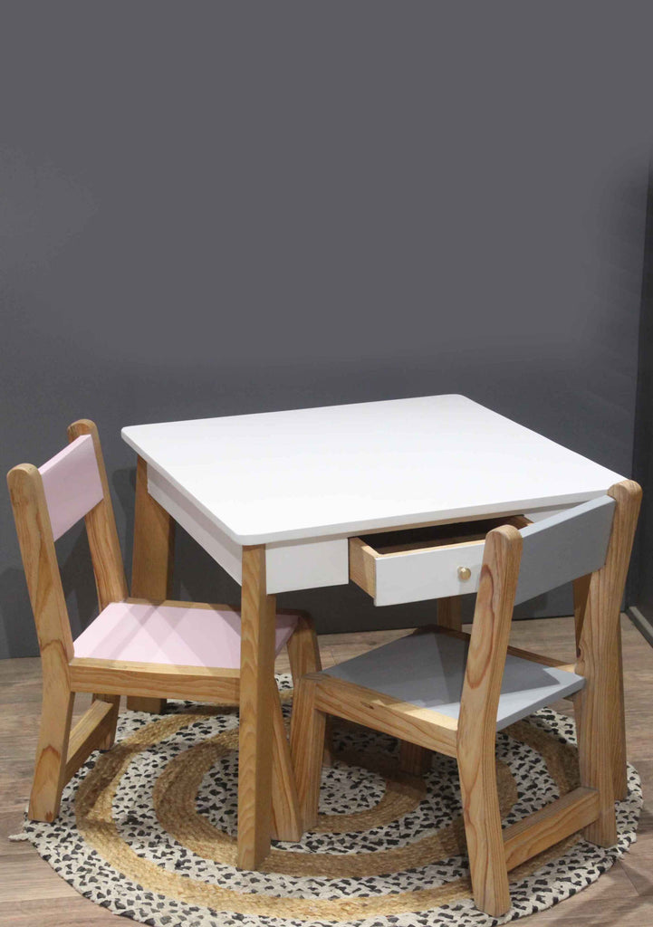 White table with pink and grey chairs