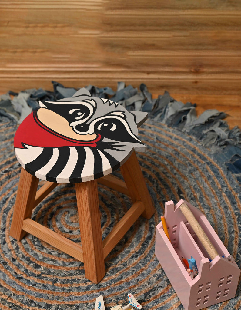 wooden seating stool with raccoon design